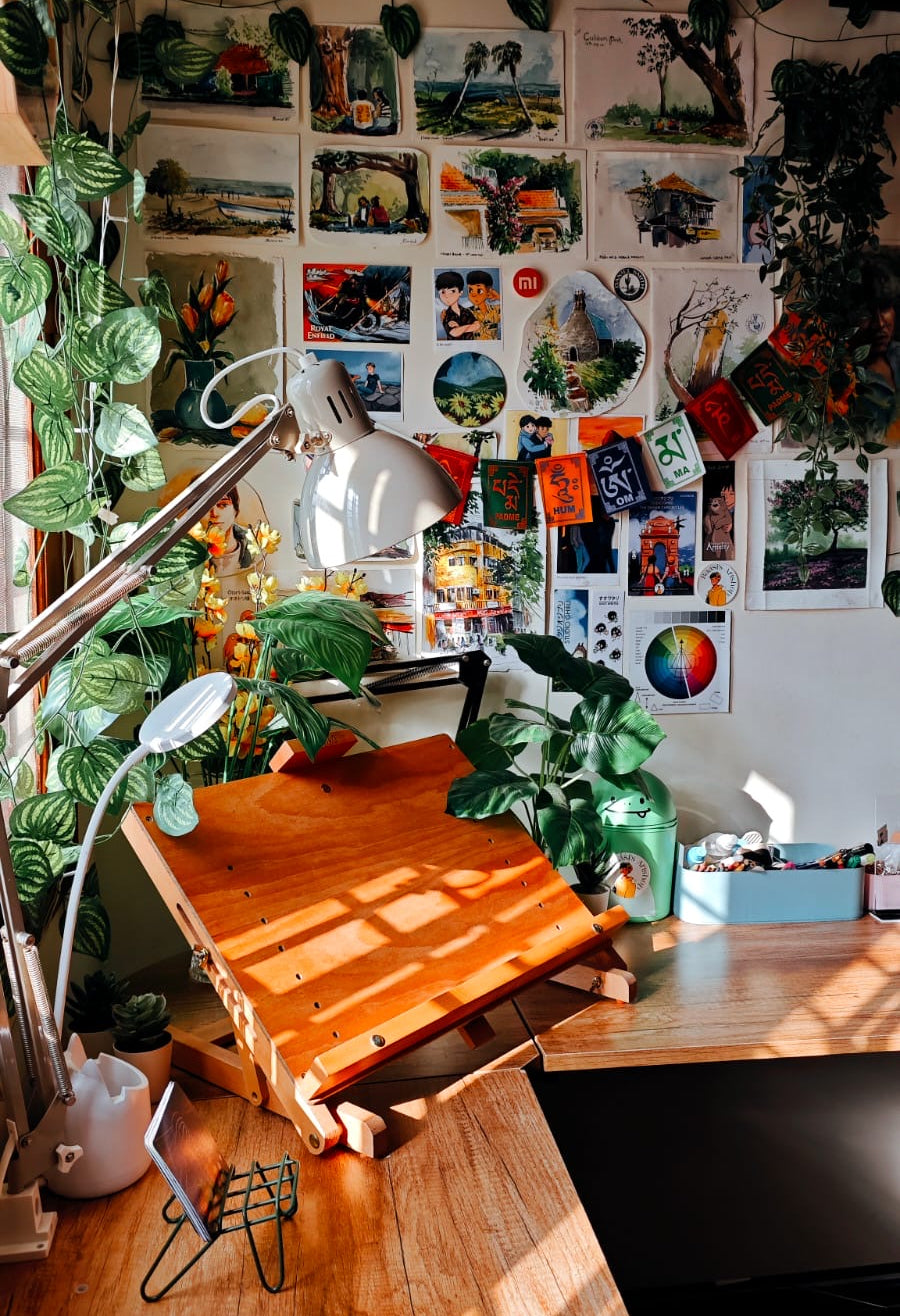My Art studio. Wooden desk with plants and artworks in a room