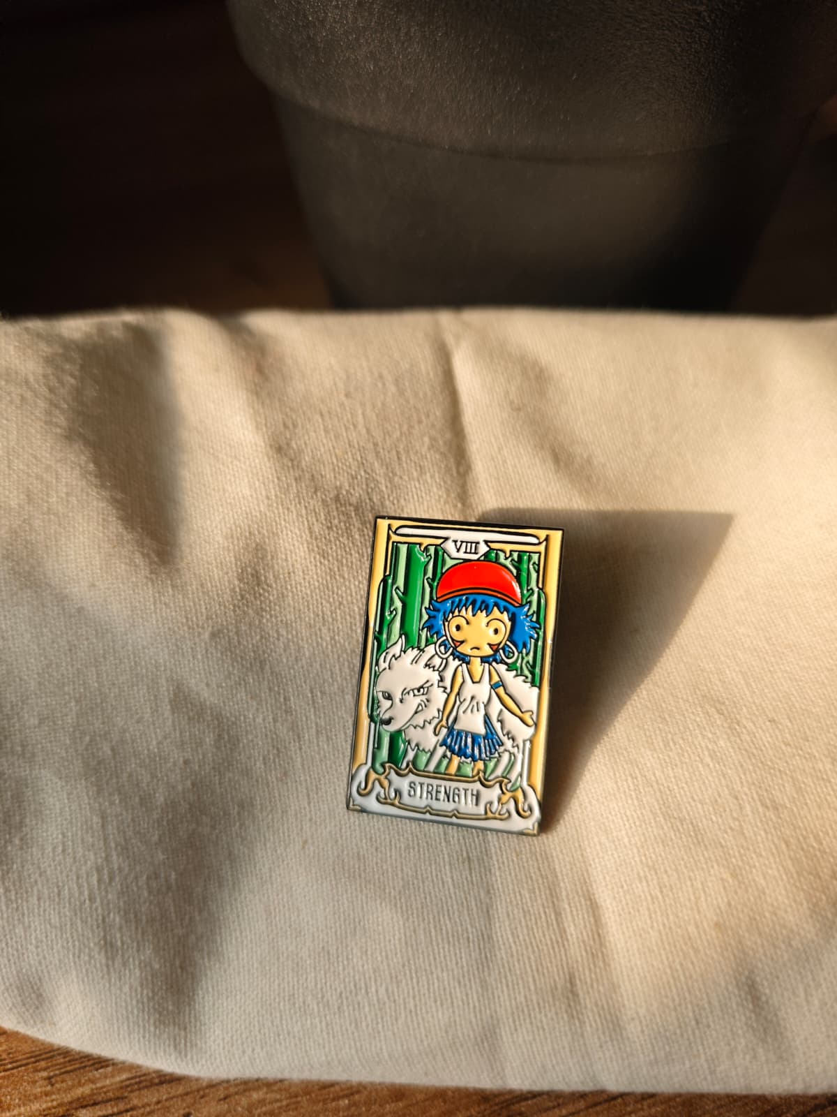 Princess Mononoke enamel pin featuring a "Strength" tarot card